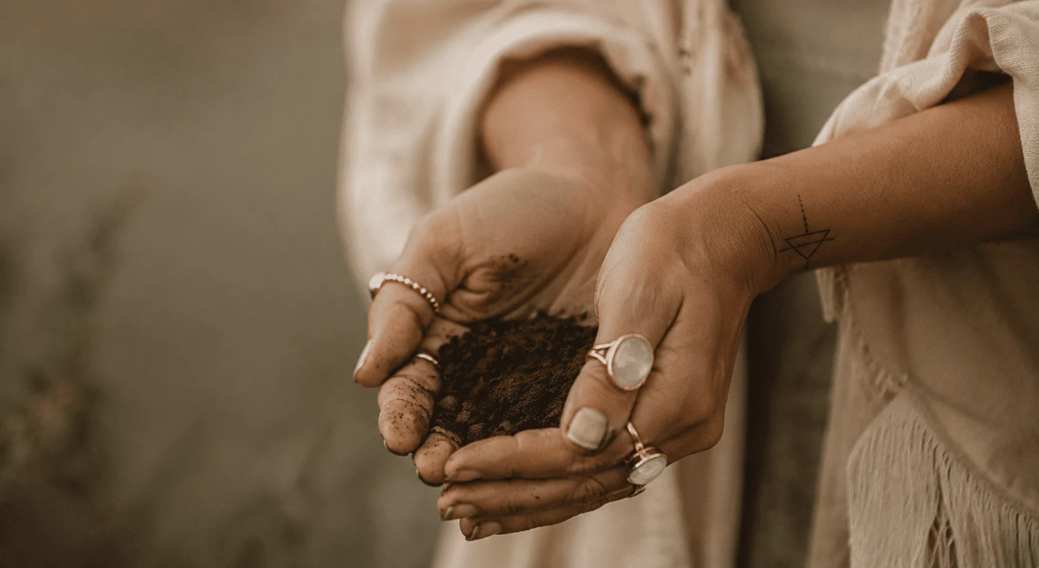 Hands gently holding soil, from the original Philosophy page