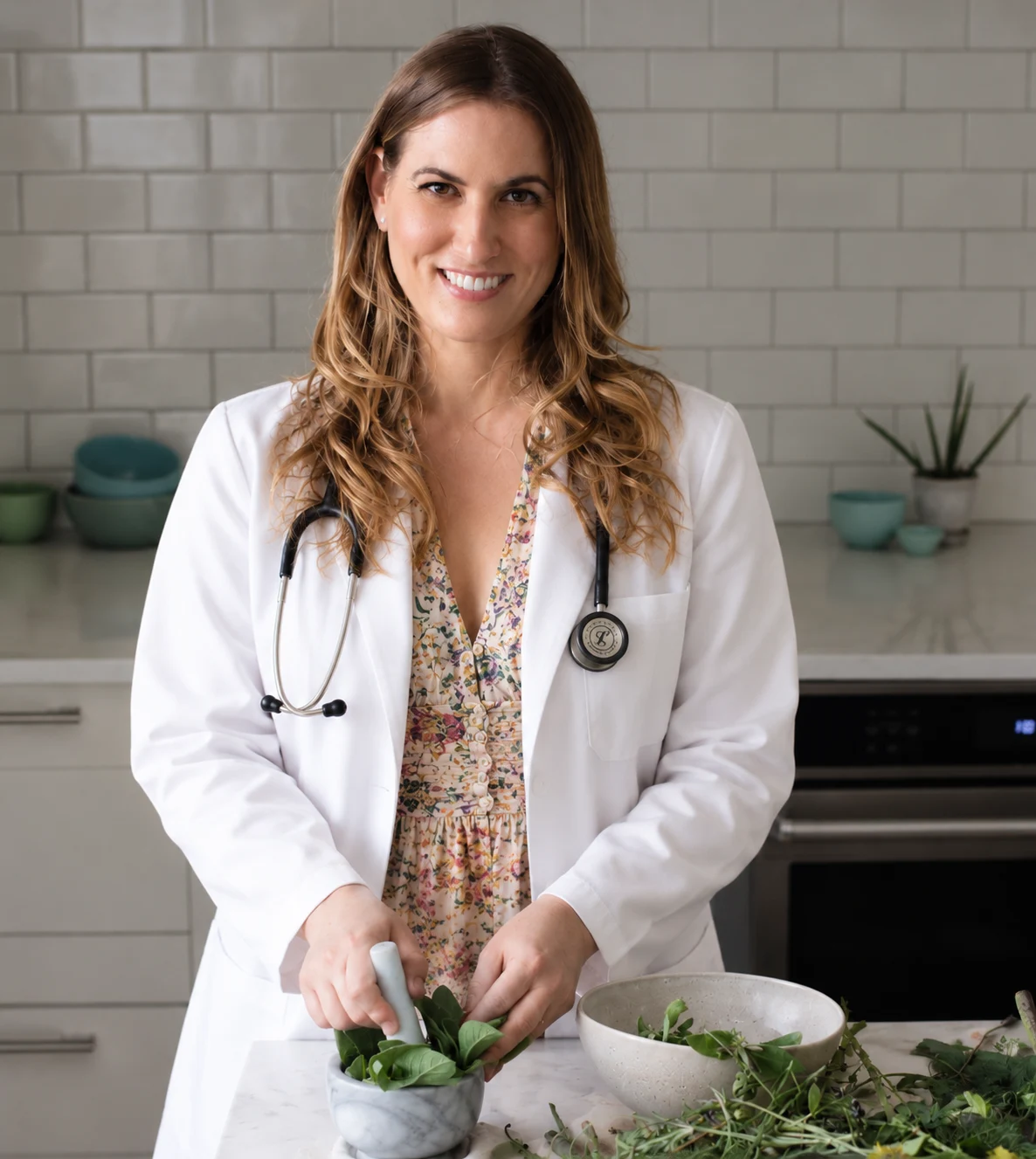 Dr. Michele Burklund in her white coat, preparing herbs